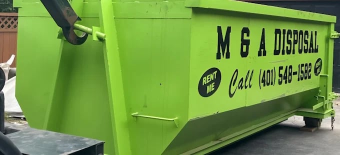 Bright green dumpster with M & A Disposal logo and contact number